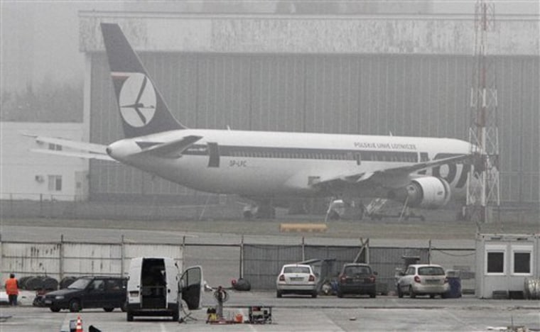 The Boeing 767 that made a safe emergency landing on its belly is back on its wheels in front of a hangar at Frederic Chopin airport in Warsaw, Poland, on Thursday, Nov. 3, 2011. 
